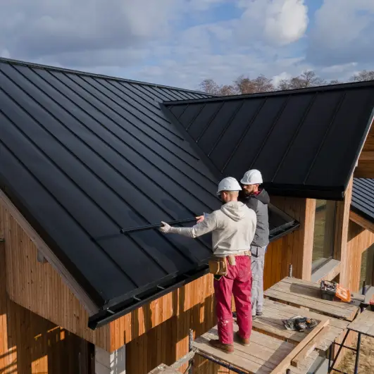 Full shot roofers working together with helmets